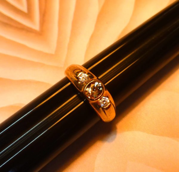 Gold plated ring with full bezel set 5mm x 4mm Oval Cut Zultanite™ and two semi bezel set full cut Diamonds.